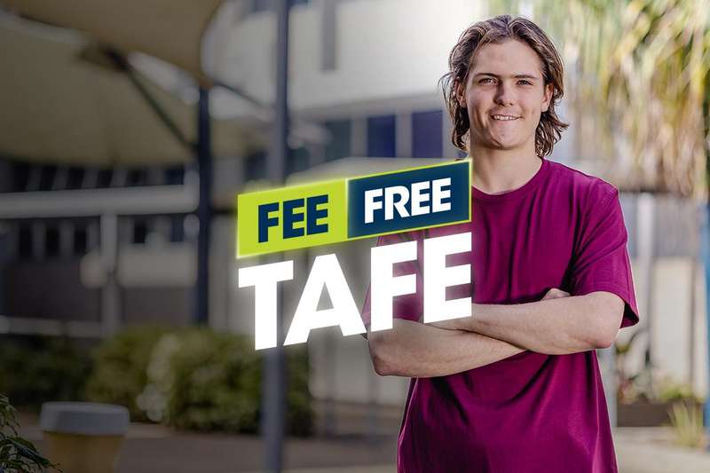 TAFE student standing with arms crossed smiling at the camera at Rockhampton City Campus
