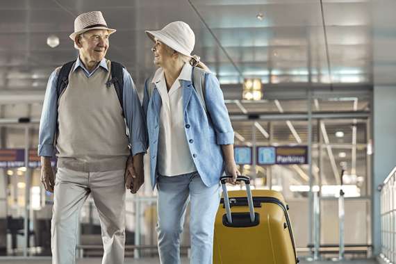 An elderly couple leaving the airport together
