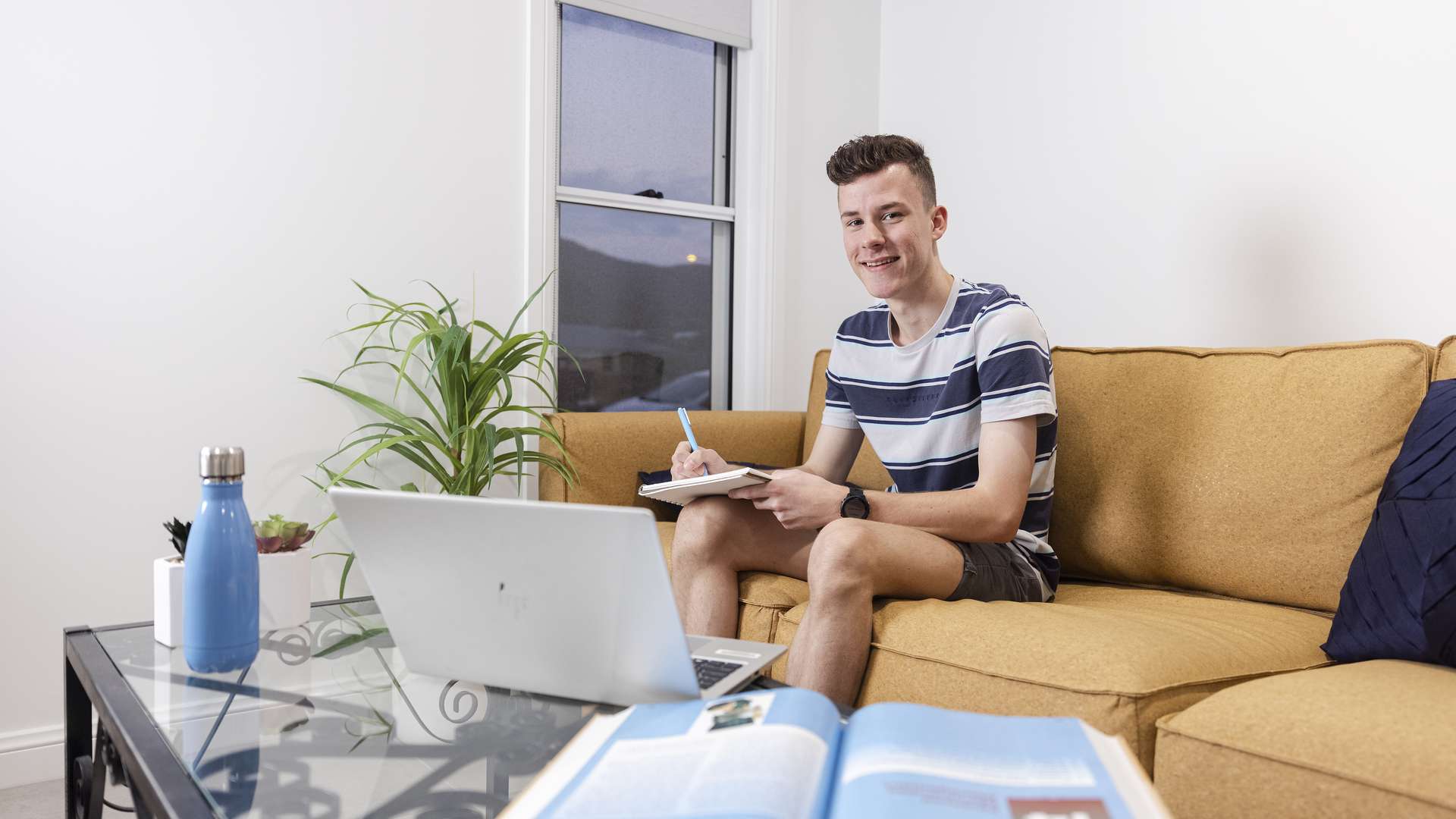 Man studying on a lounge at home.
