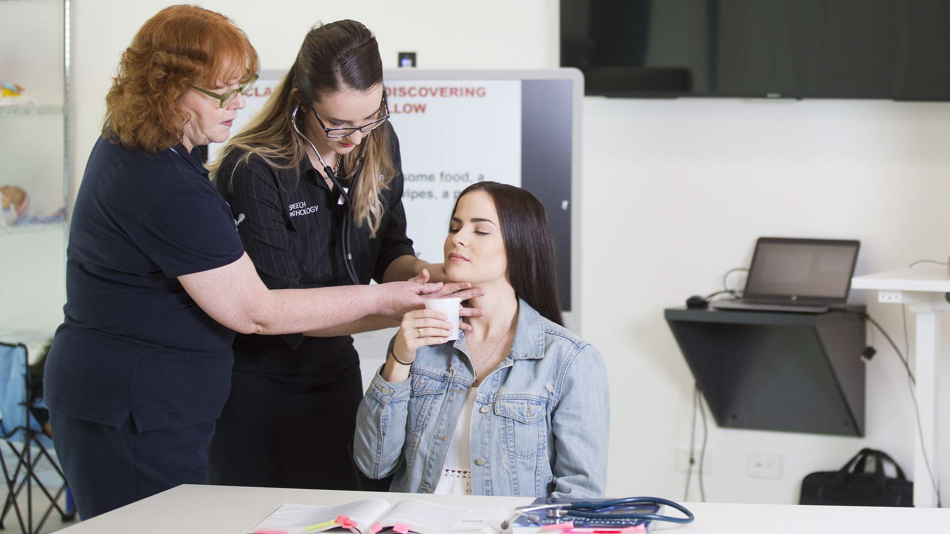 Speech Pathology student helping patient with guidance from instructor