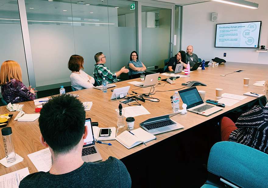 CARTA workshop attendees sitting around conference table with Dr Lee McGowan