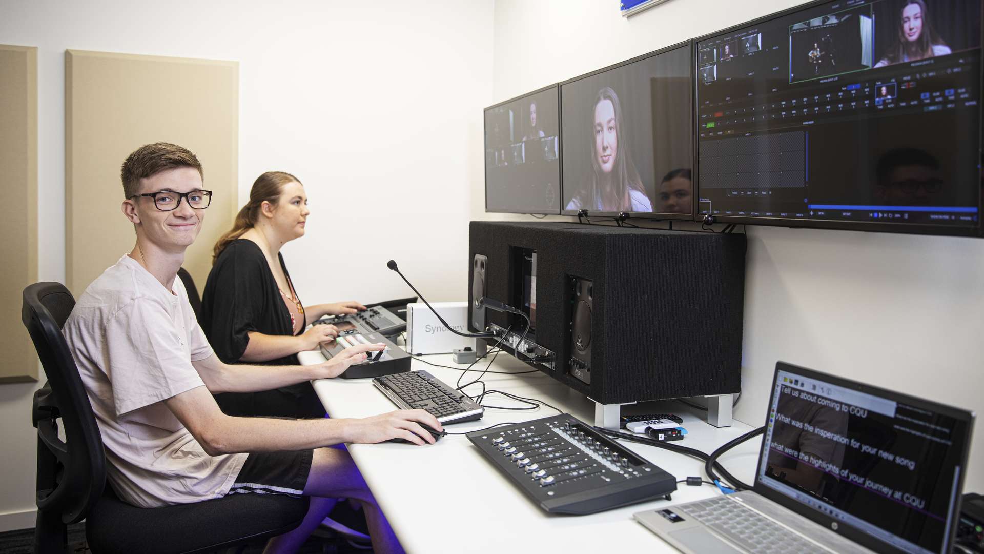 Digital Media students editing video footage on a computer