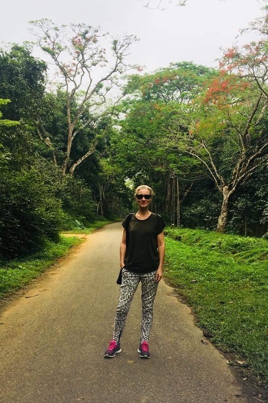 Dr Alexandra McEwan standing on a path in the rainforest of Vietnam