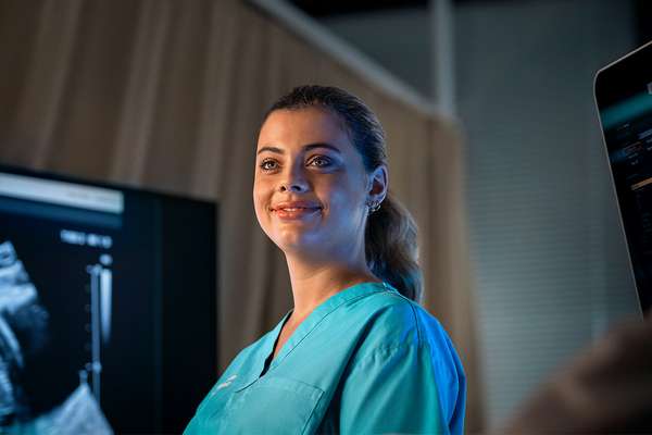 Female sonography student standing in clinic