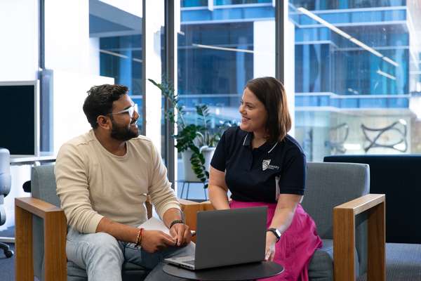 Staff and Student speaking over a laptop, Brisbane Campus