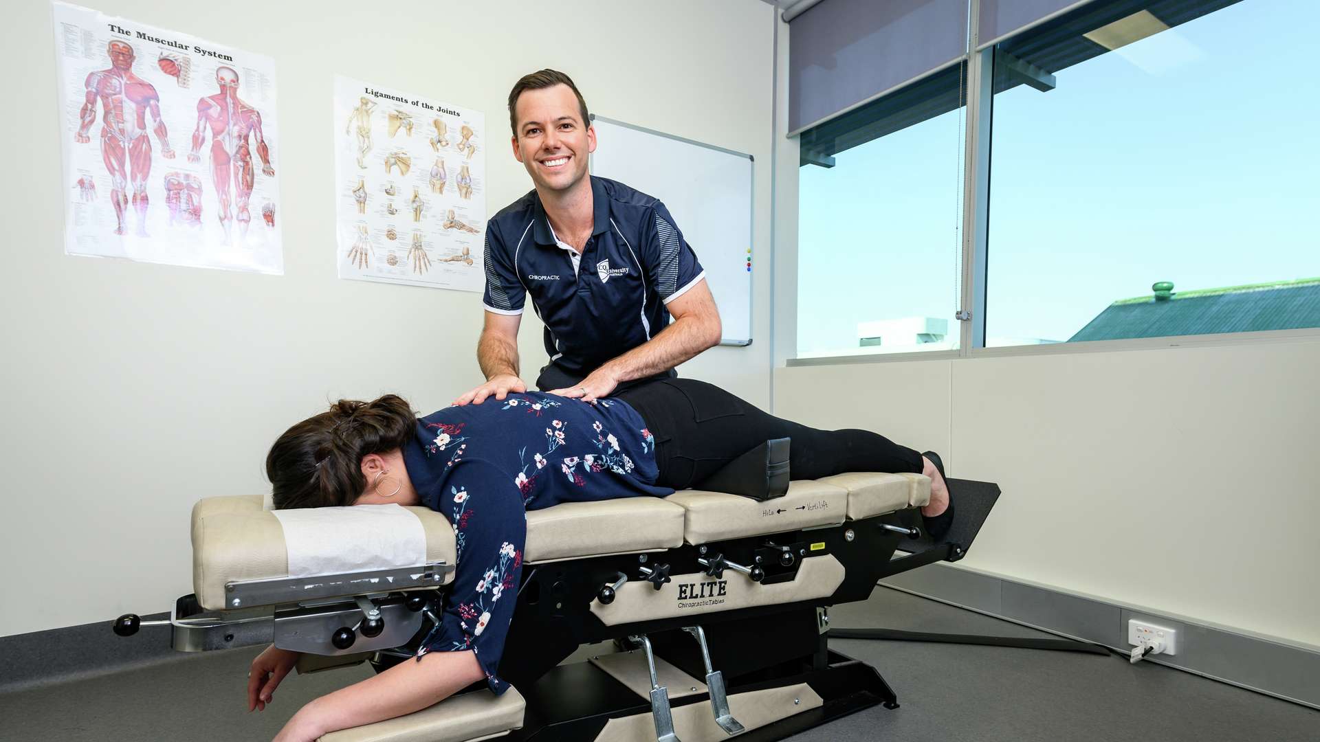 Chiropractic student giving a patient an adjustment in a CQU health clinic
