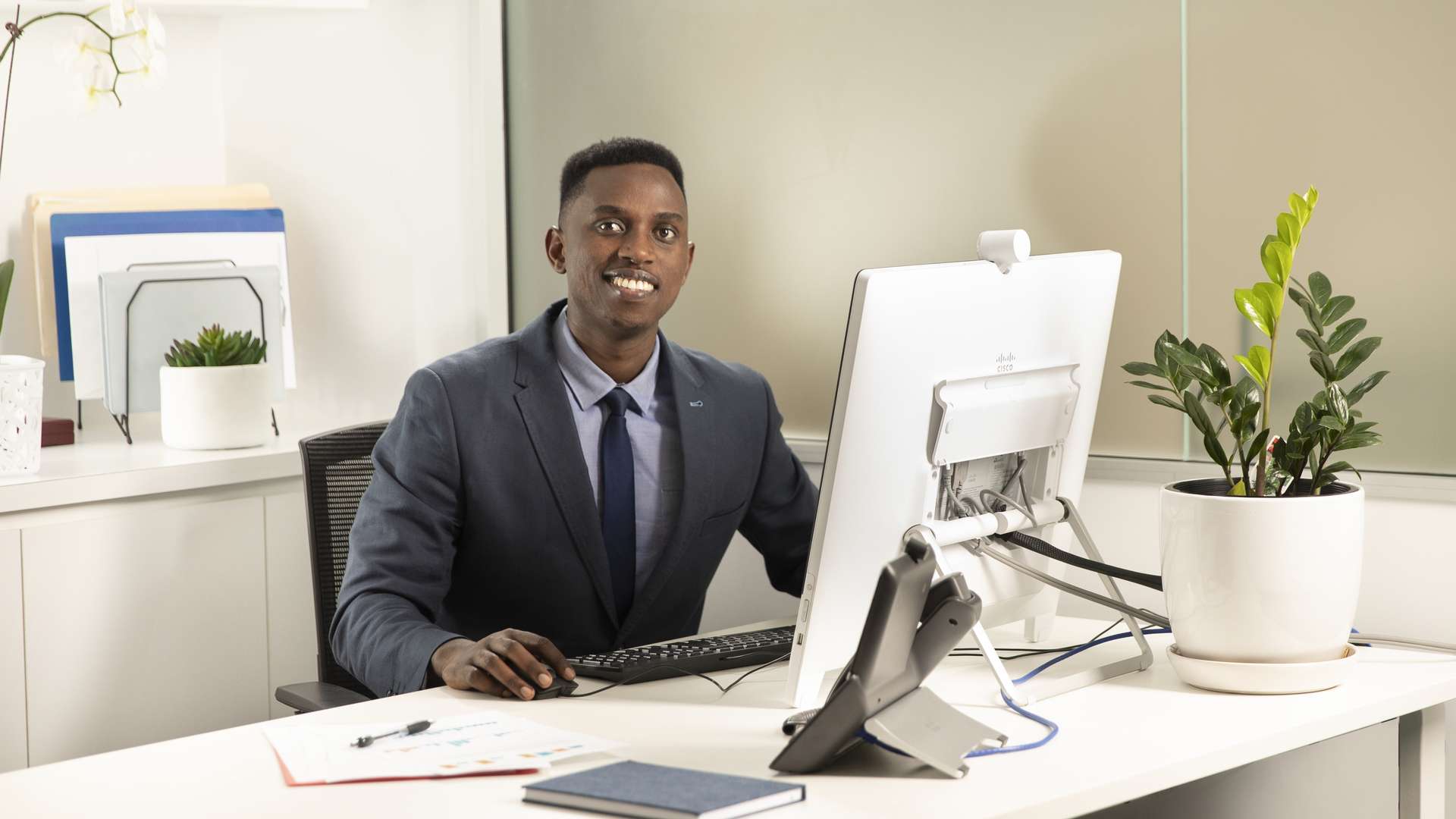 Man sitting at a desk working on a computer