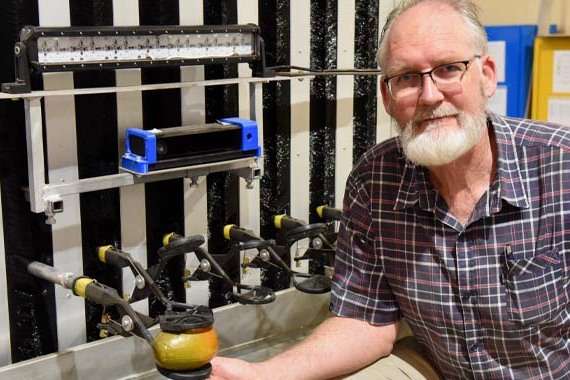 Professor Kerry Walsh with a mango harvester