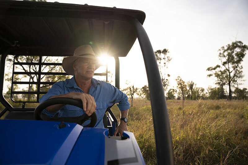 A farmer driving a tractor