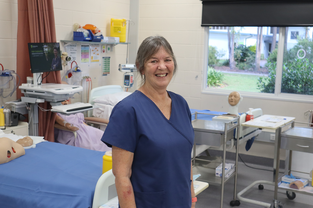 Lady in nursing scrubs in a laboratory environment