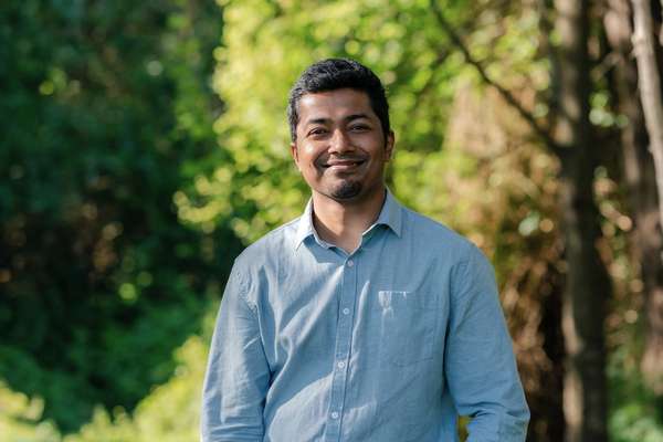 Abhishek Raha Roy Pranta smiling at camera.