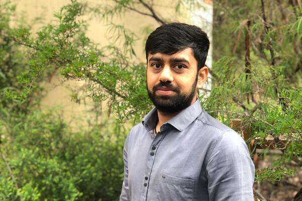 Abhishek Rameshbhai Sutariya posing in front of trees