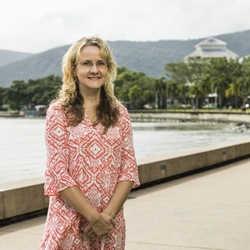 Anja Pabel smiling for a photo by an inner city lake