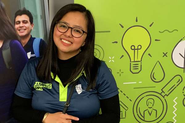 Ariane Dultare standing at a Brisbane Campus event booth