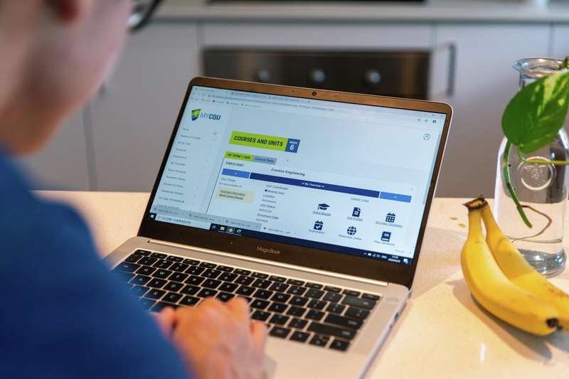 Student at their laptop visiting a CQU webpage