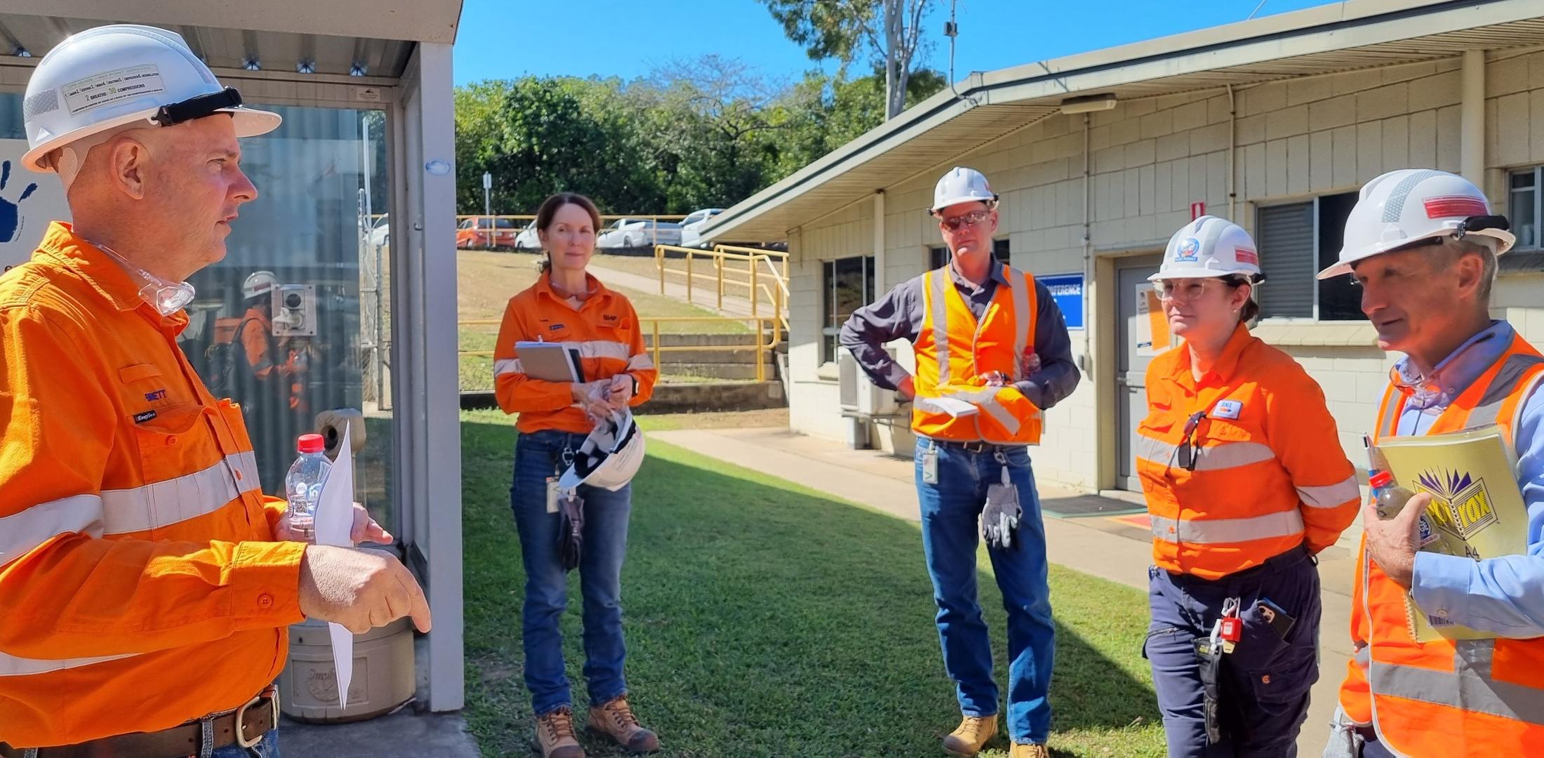 Professor Rob Brown standing with BHP representatives in PPE as they tour around the BHP Hay Point Coal Terminal