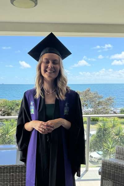 Alumna Breanna Morgan wearing graduation regalia