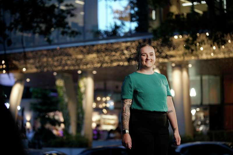 A Brisbane CQU student standing and smiling at the camera.