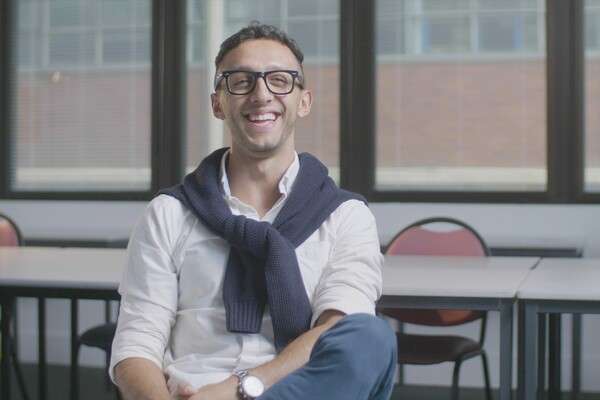 Colombian Student, Carlos Bravo Ocampo smiling at camera whilst sitting in a classroom