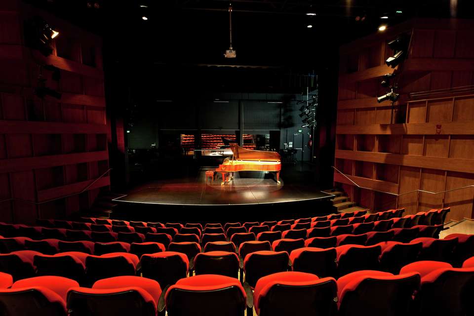 View from the seats in the CQCM Conservatorium looking at the stage with a piano on it