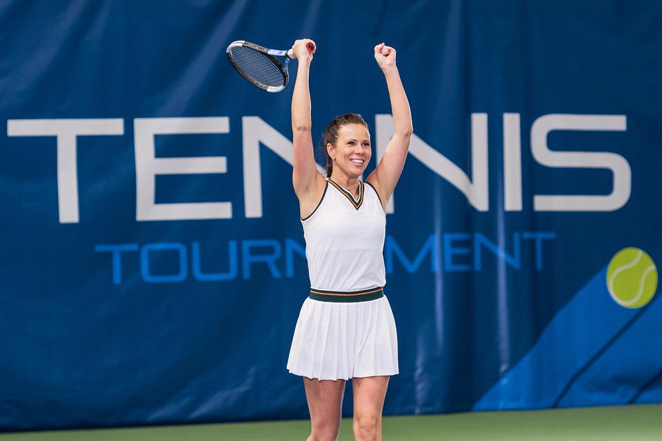 Tennis player celebrating a win on court at a tennis tournament