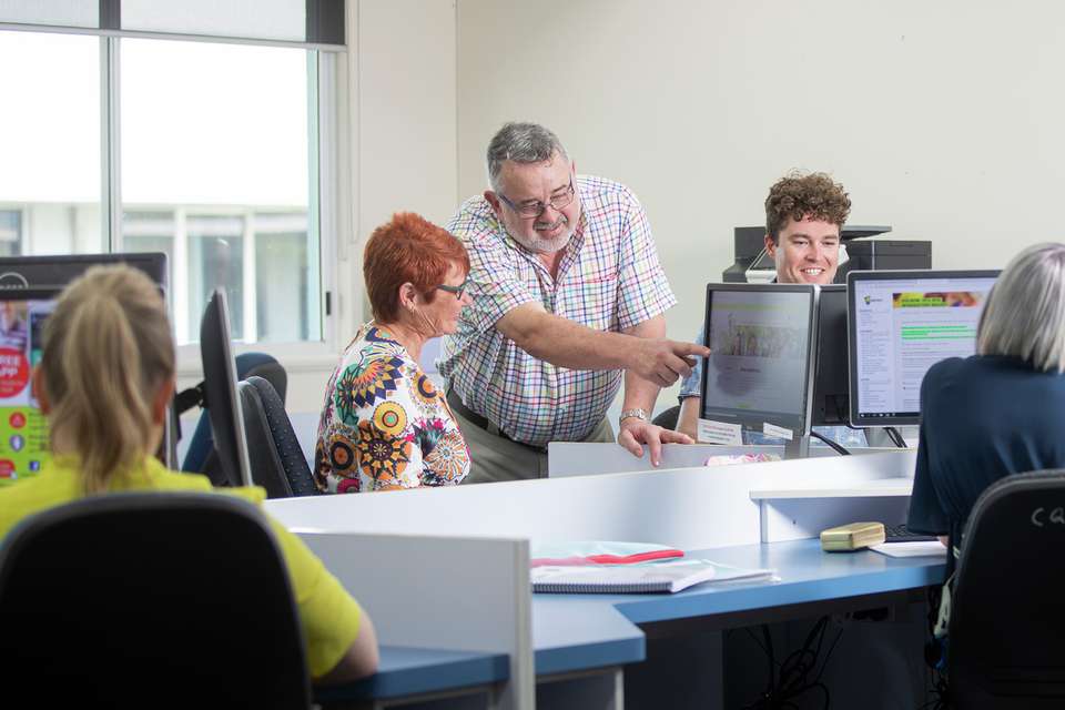 A STEPS teacher helping a student