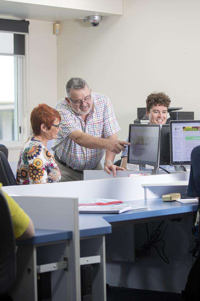 A STEPS teacher helping a student