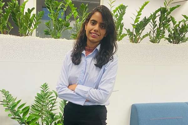 Deeksha Rahanoo smiling with crossed arms