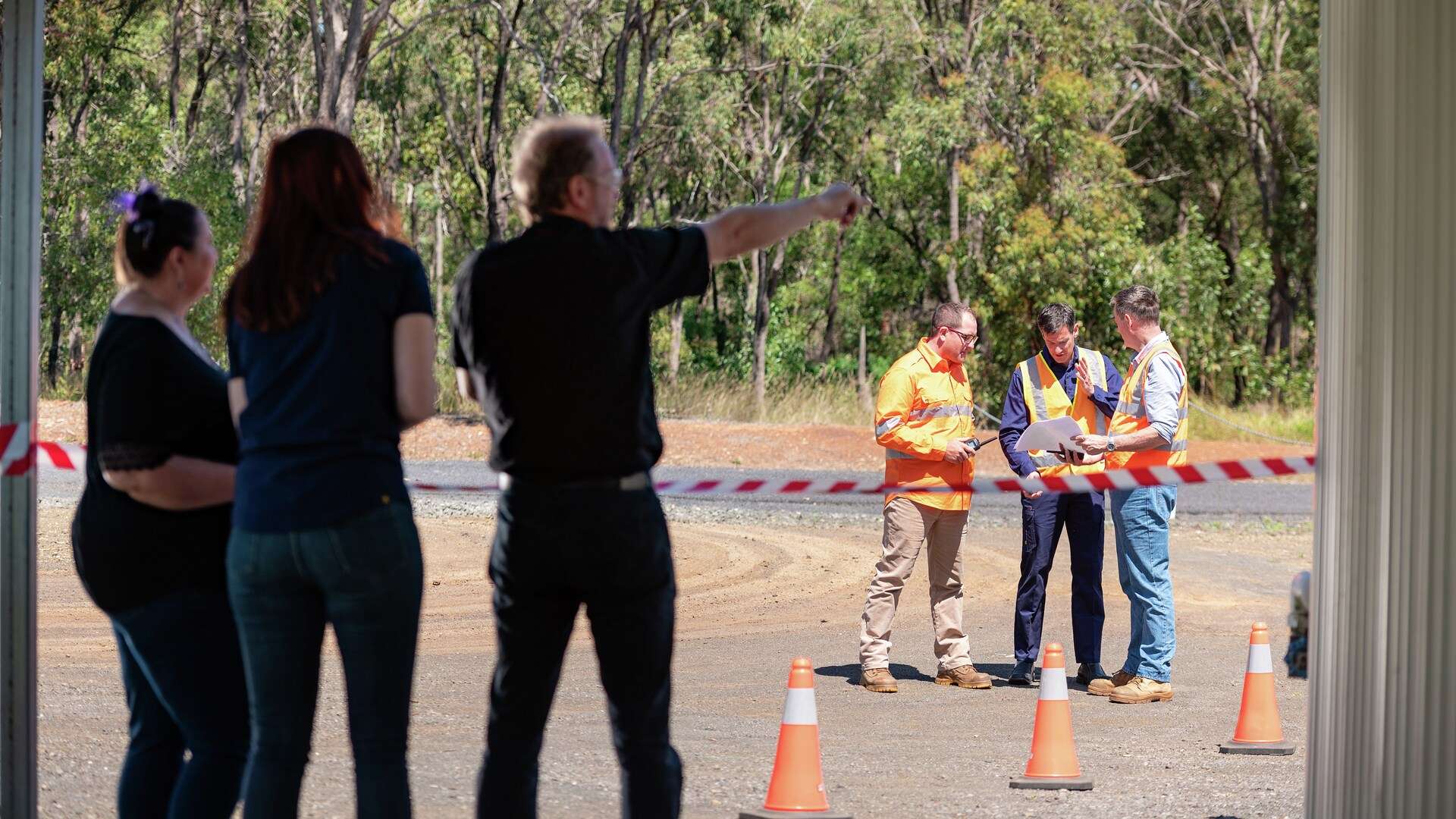 Three Emergency and Disaster Management teachers supervising three students in a practical simulation