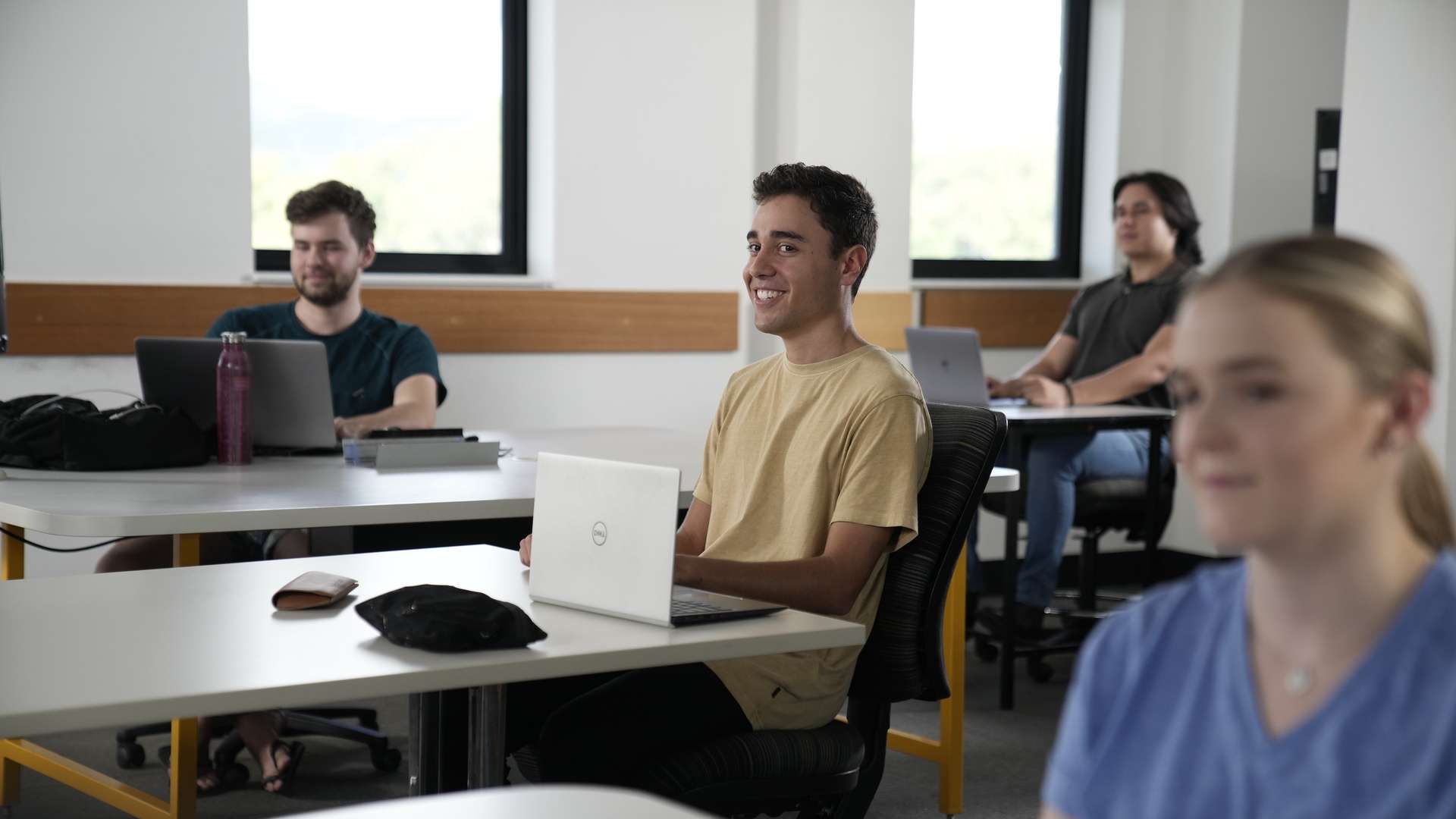 CQU student smiling in a classroom.