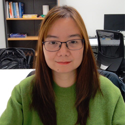 Mai Nguyen sitting in an office smile at the camera