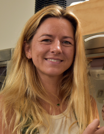 seaweed researcher Emma Theobald with seaweed spores in a beaker