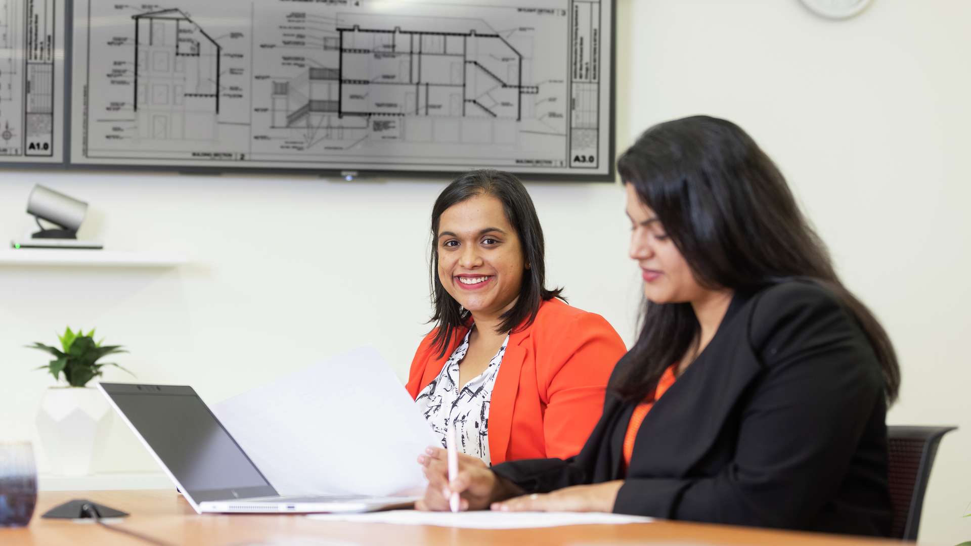 Engineering students smiling while studying.