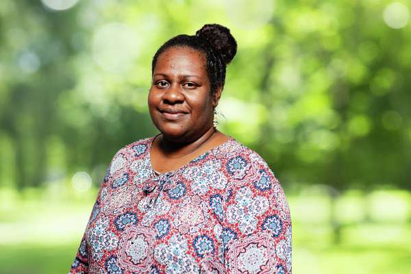 Eunice Eva smiling with trees in her background