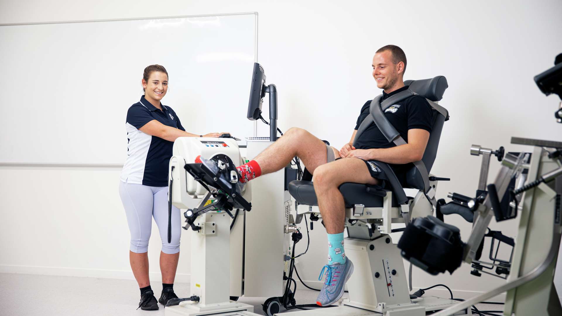 Exercise and Sports Science students using a sport science machine