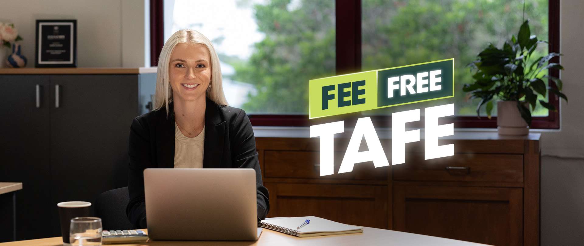 TAFE student sitting at a desk with a laptop studying