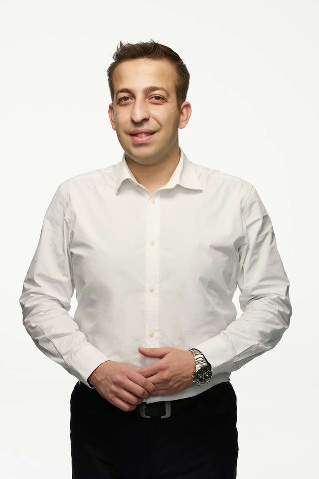 Alumnus Gokcan Hamutoglu in a white shirt