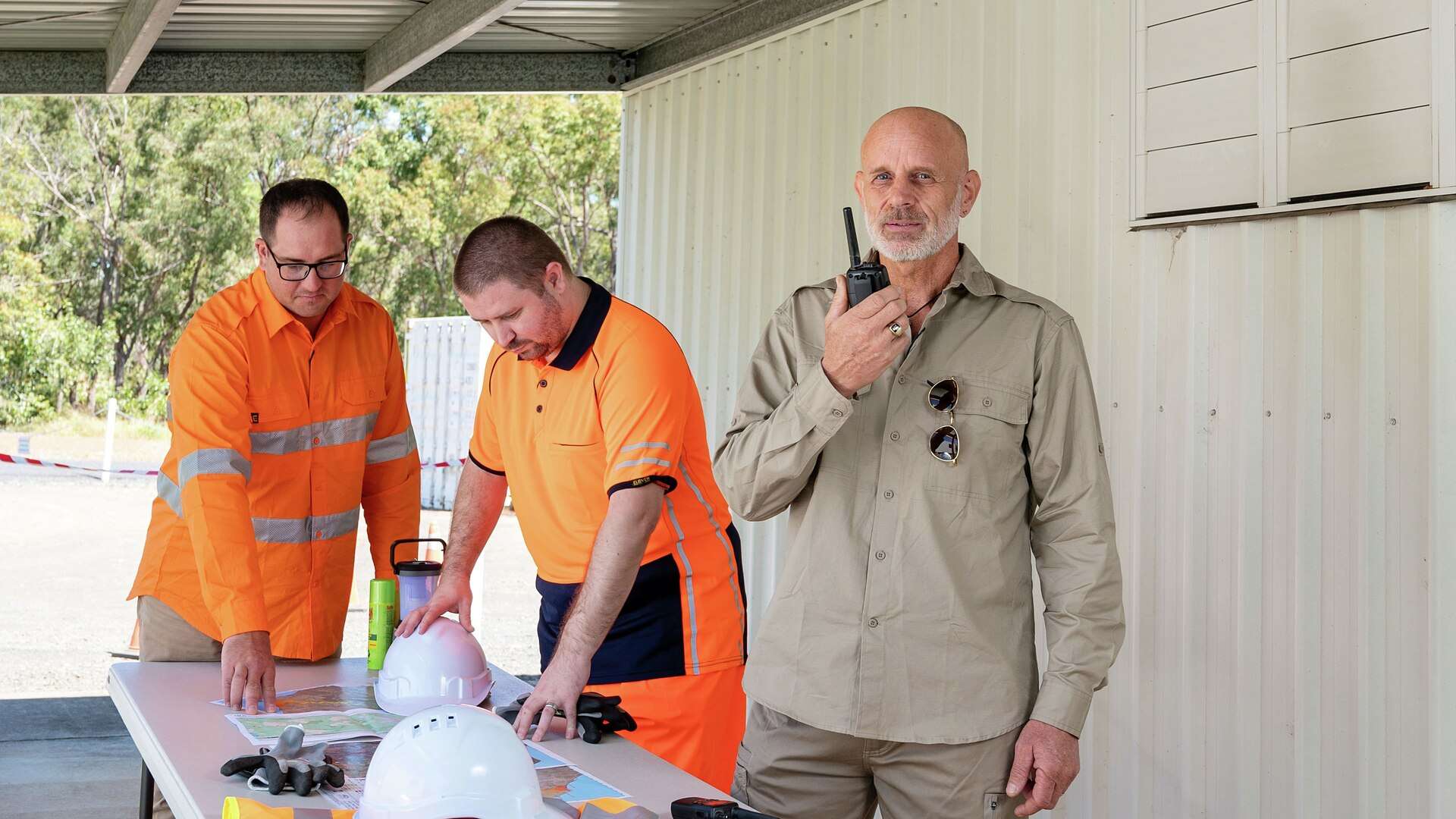 Emergency Disaster Management students using maps and a walkie talkie