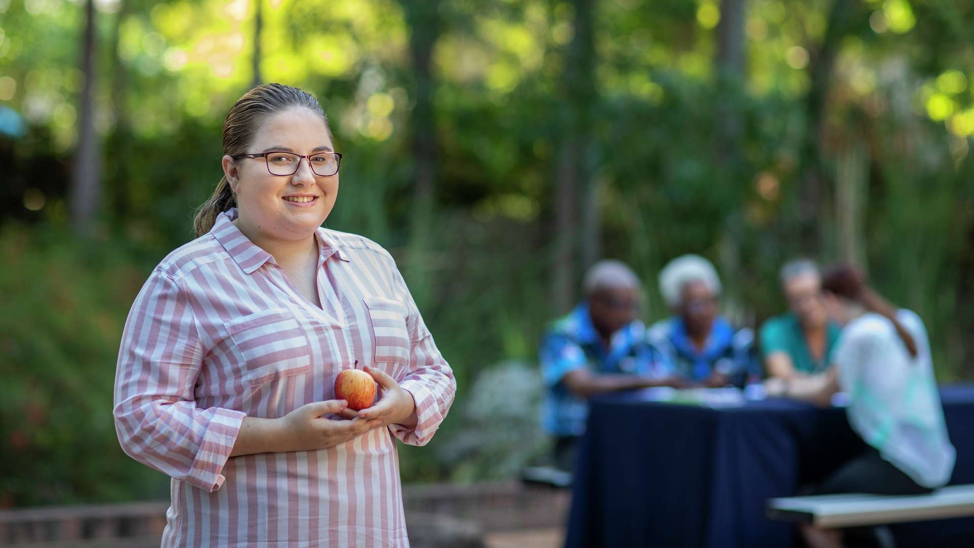 a Public Health student holding an apple
