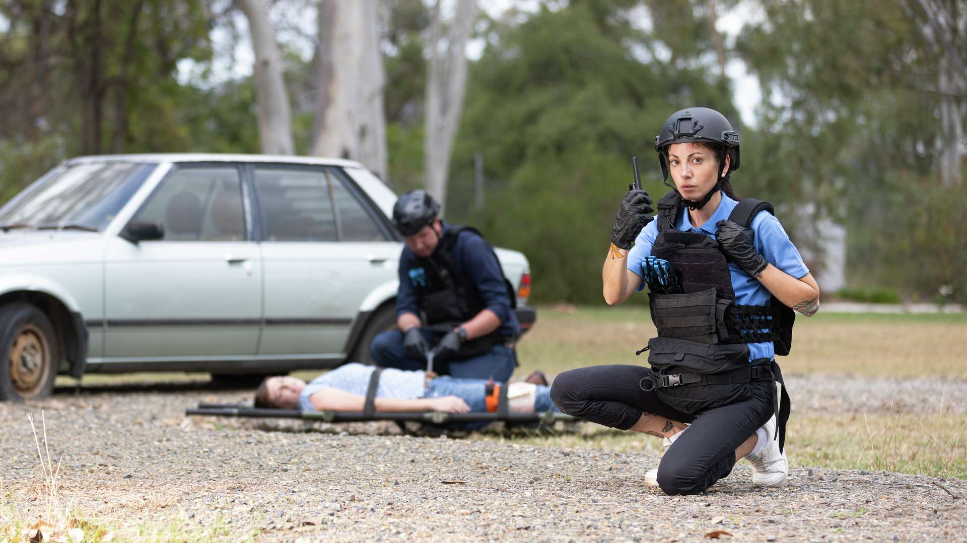 tactical medicine students assisting a patient in an outdoor simulation