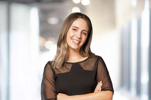 Hannah Thompson smiling with crossed arms