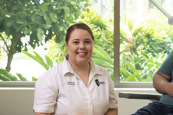 Hayley Van Den Berg examining a patients foot in a CQU health clinic