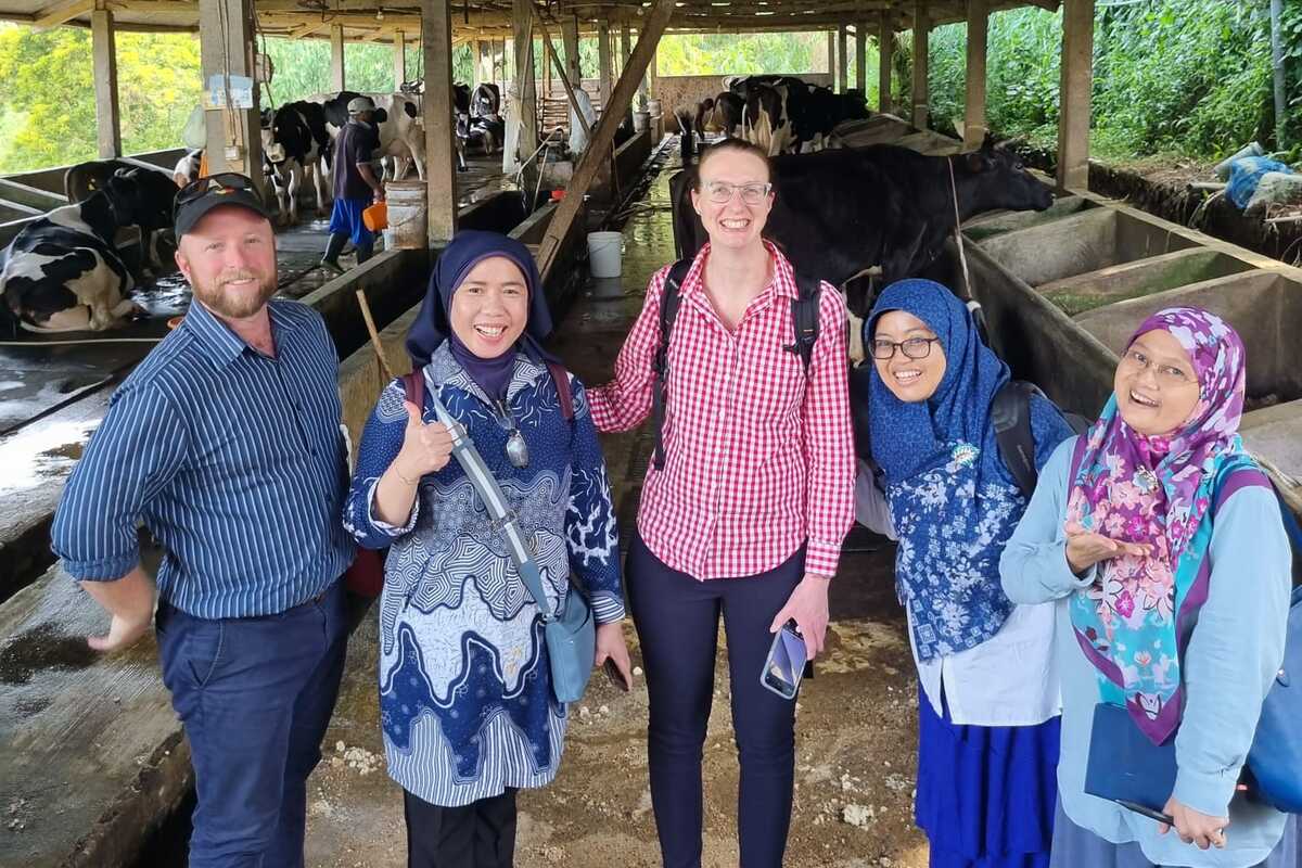 Researchers from CQU and ICASEPS standing at a milk cooperative site in West Java.
