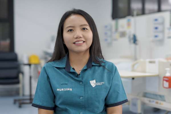 CQU Nursing student, Ivy Vana, smiling in uniform, in a medical room