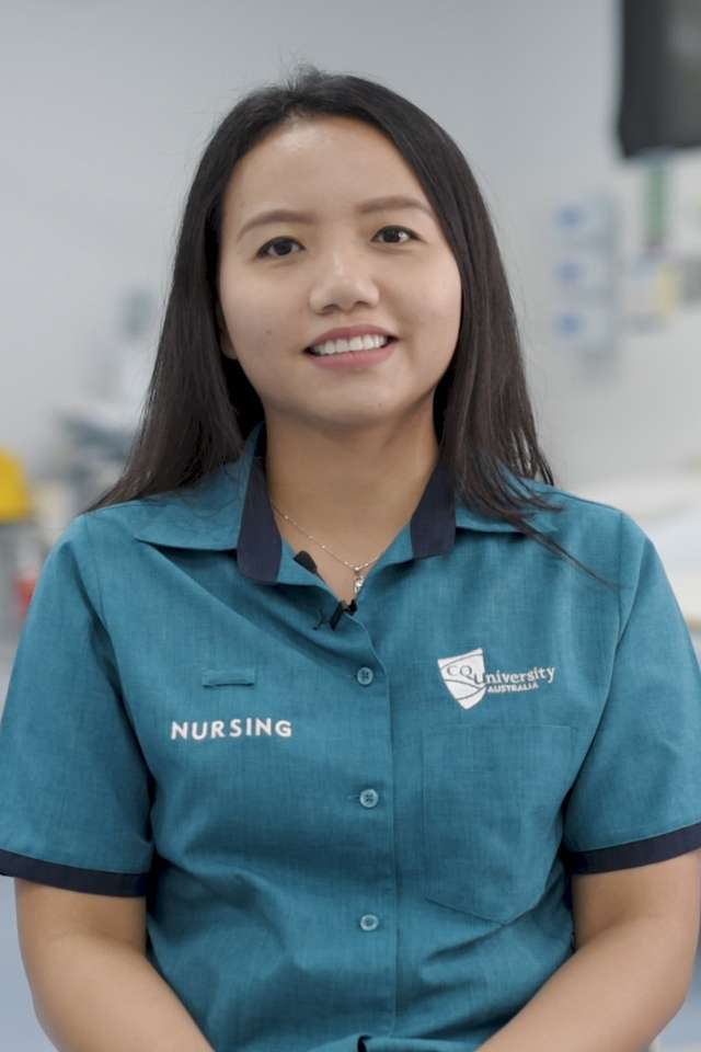 CQU Nursing student, Ivy Vana, smiling in uniform, in a medical room