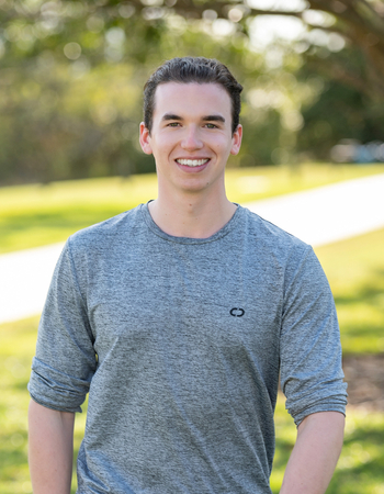 Jack Greenshields walking in a park smiling at the camera