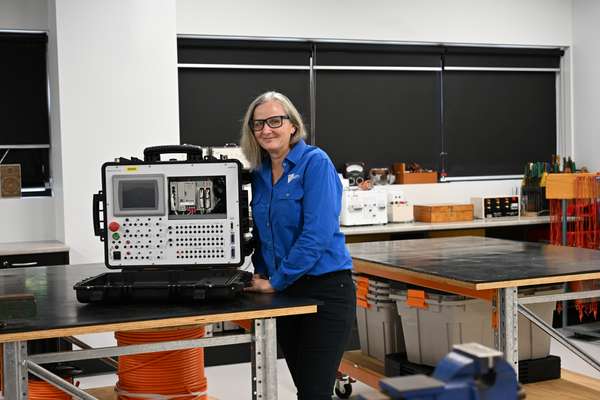 Image of a woman in an electrical training enviornment