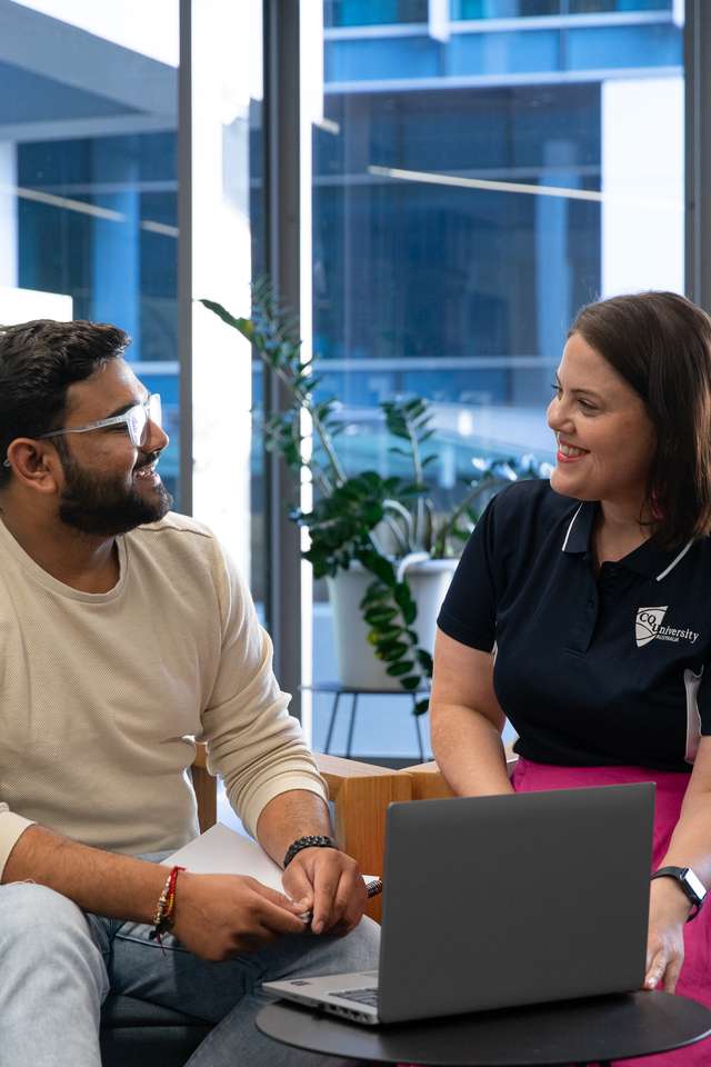 Staff and Student speaking over a laptop, Brisbane Campus