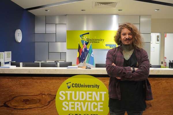 Manuel Nylen standing by the reception desk at the CQU Cairns campus