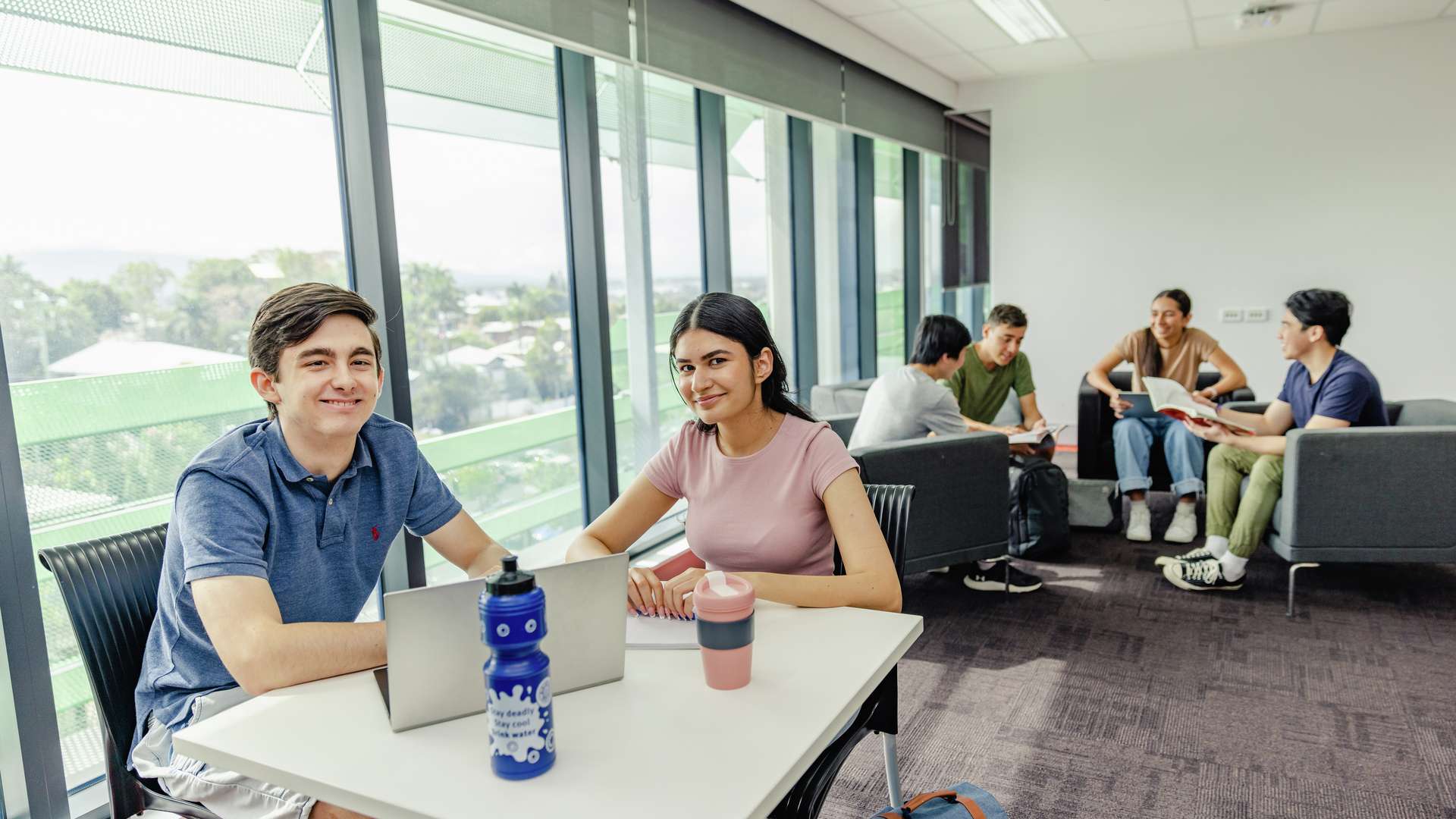 Medical students seated in a room studying and socialising.